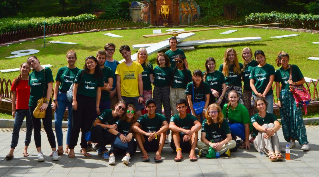 Young volunteers explore Cambodia during their team trip. A team of volunteers take a group photo outside Wat Phnom in Cambodia.